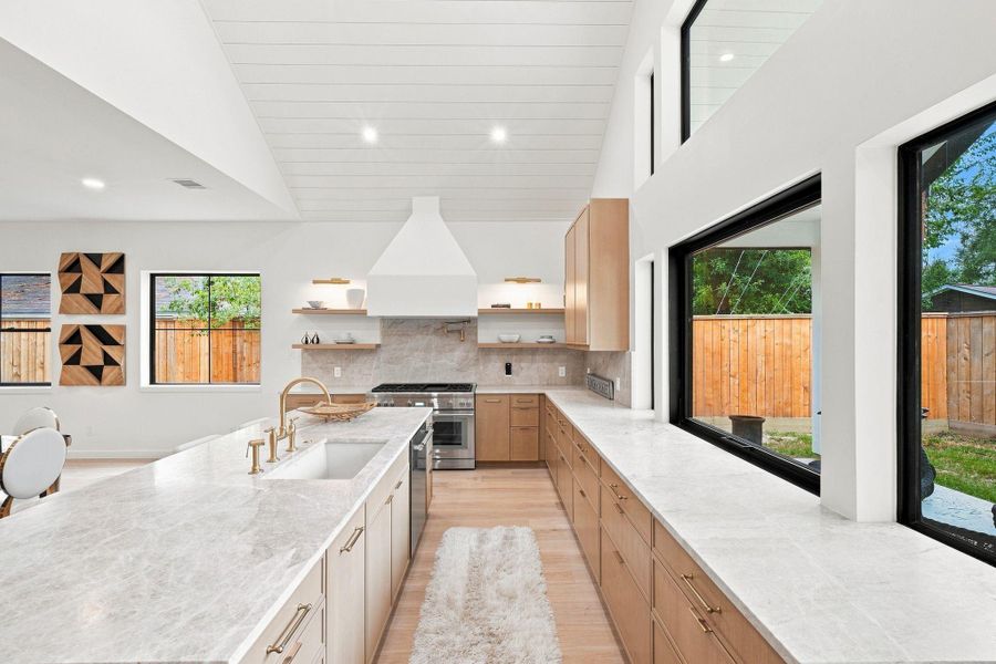 Kitchen with custom cabinets, Taj Mahal countertops, and Thermadore appliances.