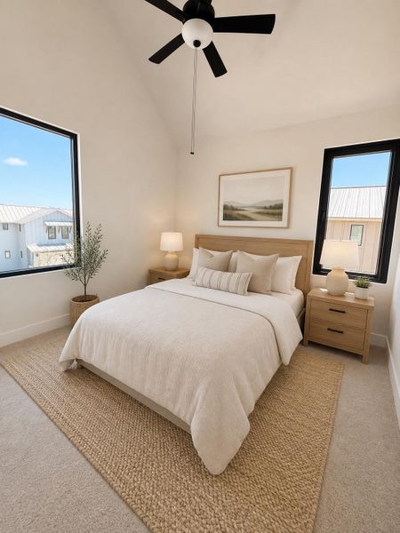 An inviting sleeping space with vaulted ceilings and oversized windows offering a peaceful retreat.