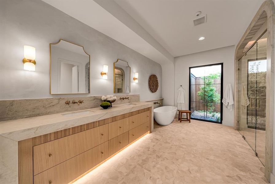 Full bath featuring double vanity, a soaking tub, a stall shower, and recessed lighting