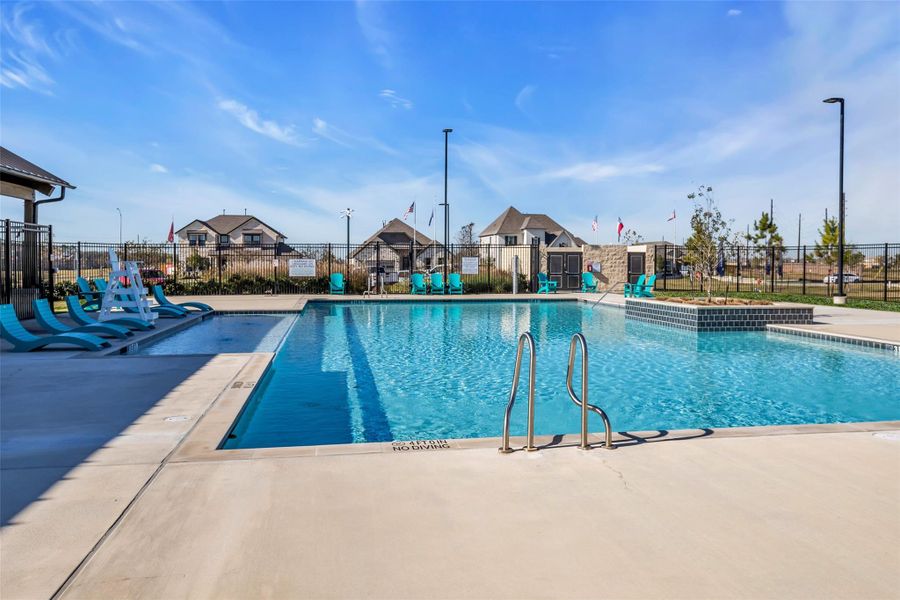 Neighborhood amenity featuring a pool and surrounding deck area, offering a built-in option for outdoor relaxation. Neighborhood amenity featuring a pool and surrounding deck area, offering a built-in option for outdoor relaxation.