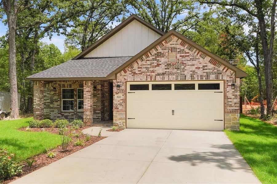 Brick exterior with stone accents and a gabled roofline Brick exterior with stone accents and a gabled roofline