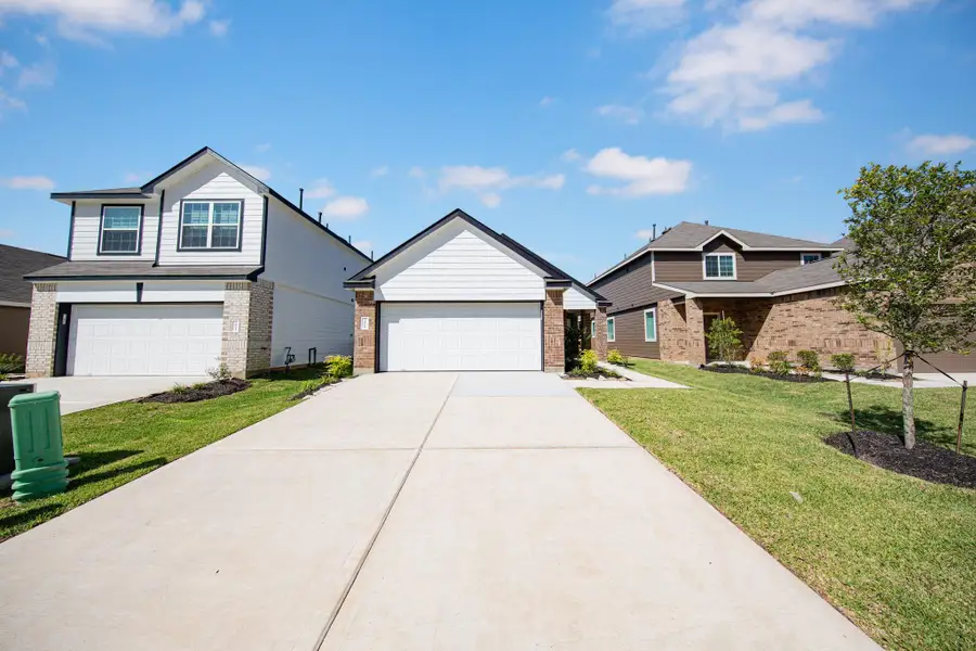 Front exterior of a new home in Mackenzie Creek, Conroe, TX, highlighting curb appeal (Image 2). Front exterior of a new home in Mackenzie Creek, Conroe, TX, highlighting curb appeal (Image 2).