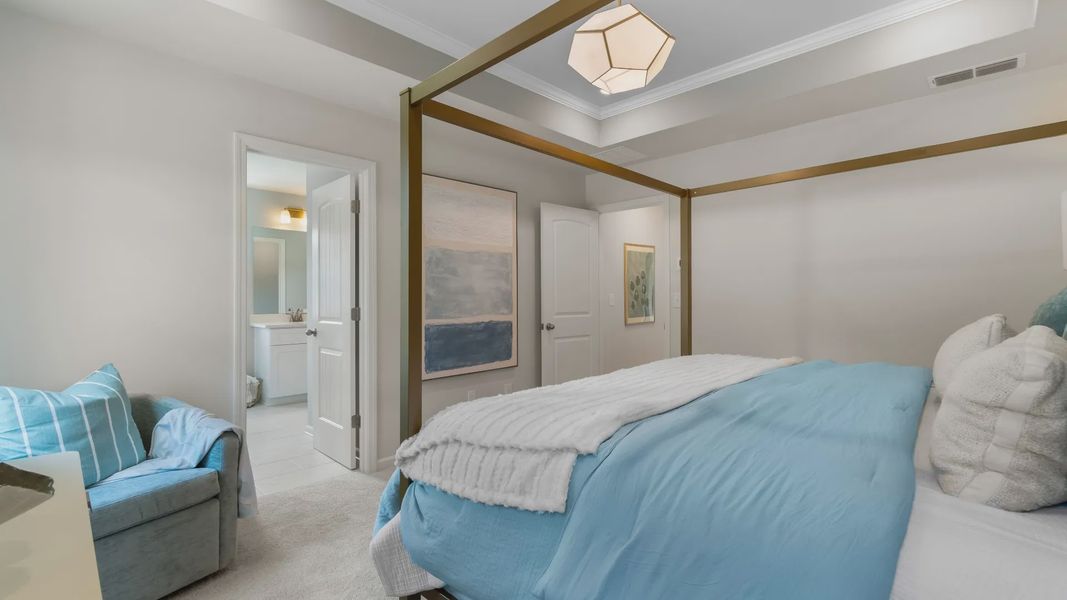 Stylish primary suite in new contruction townhome featuring soft textiles and calming neutral palette.