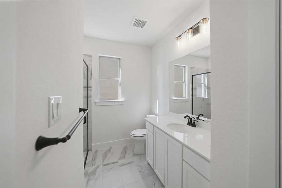 Full bath with vanity, a stall shower, and light marble finish floors Full bath with vanity, a stall shower, and light marble finish floors
