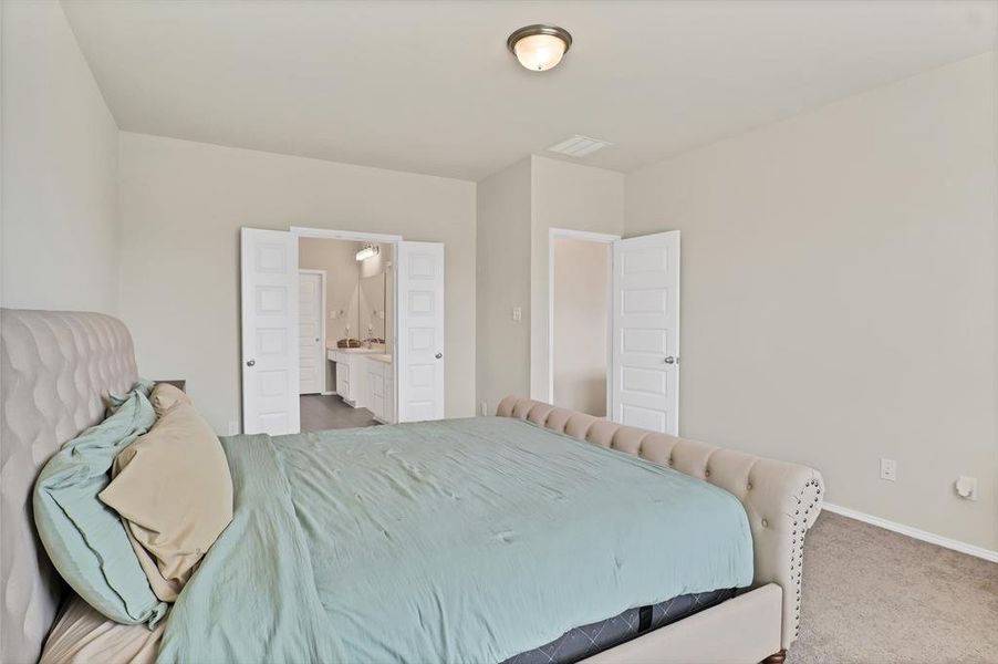 Carpeted bedroom with ensuite bath