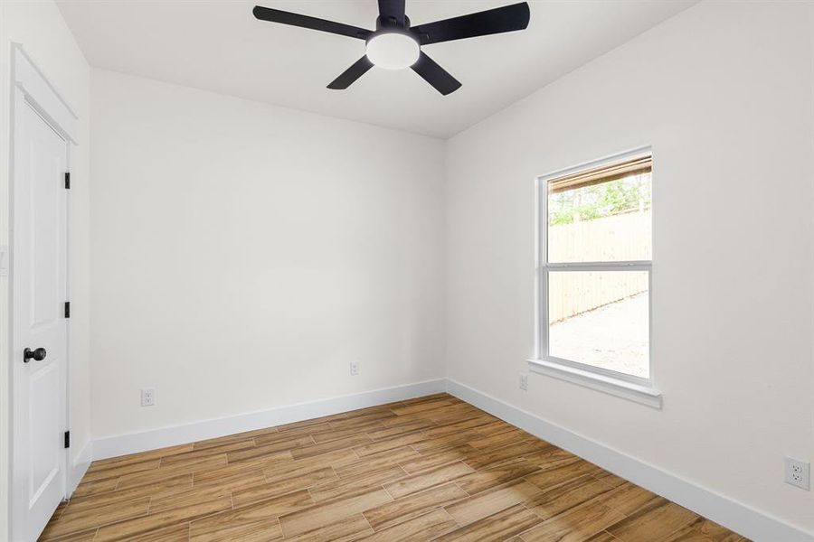 Unfurnished room featuring light hardwood / wood-style flooring and ceiling fan