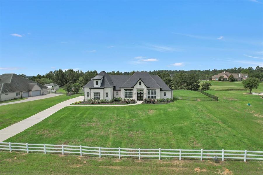 Front view of the home, showing the space around. Driveway is stamped and stained at the road. Area is currently zoned for Lake Creek HS, MISD.