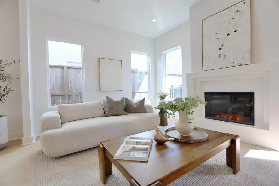 The fireplace wall features an architecturally layered design that draws the eye with its dimension.