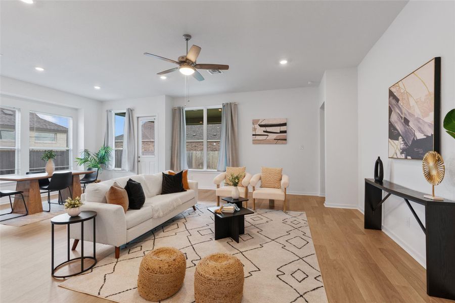 A flowing layout with warm wood type floors and abundant natural light.
