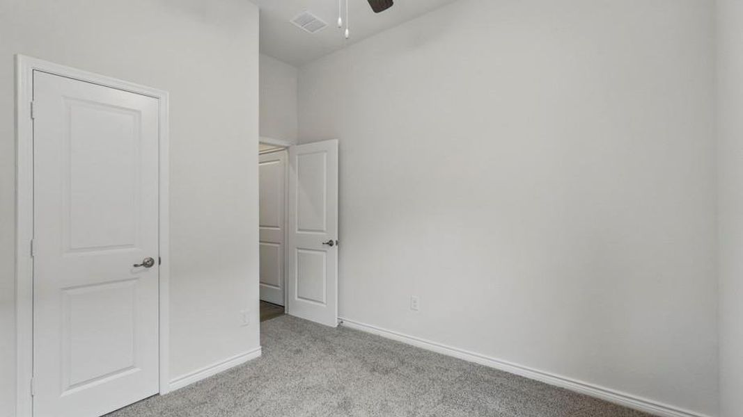 Neutral paint palette and light gray carpeting define this interior space