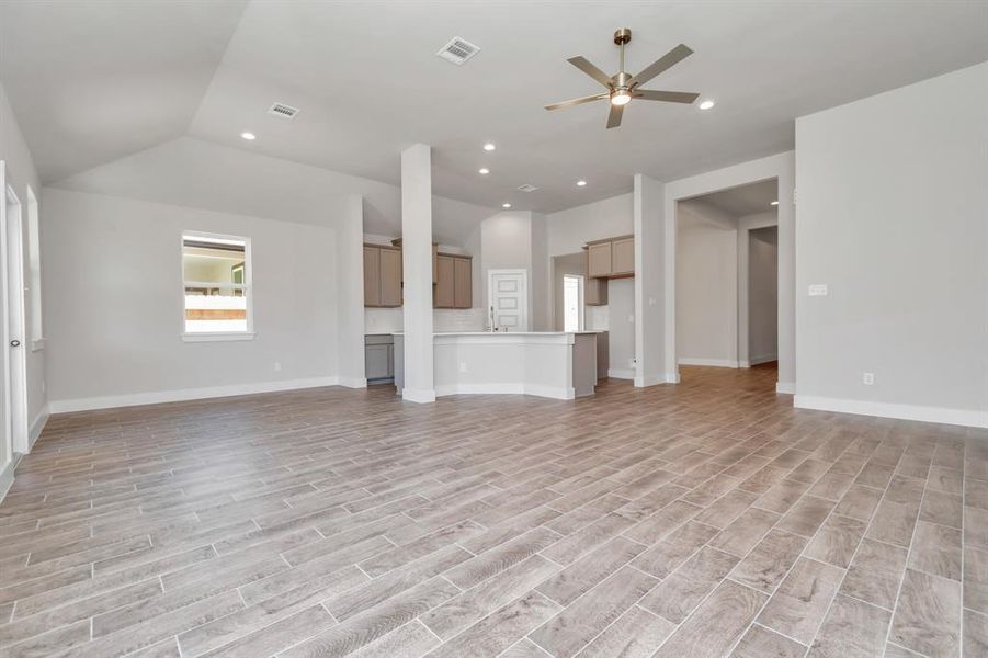 Take another glimpse into the heart of the home with this additional view of the family room—a sprawling space ready to accommodate all your gatherings. Sample photo of completed home. Actual colors and selections may vary.