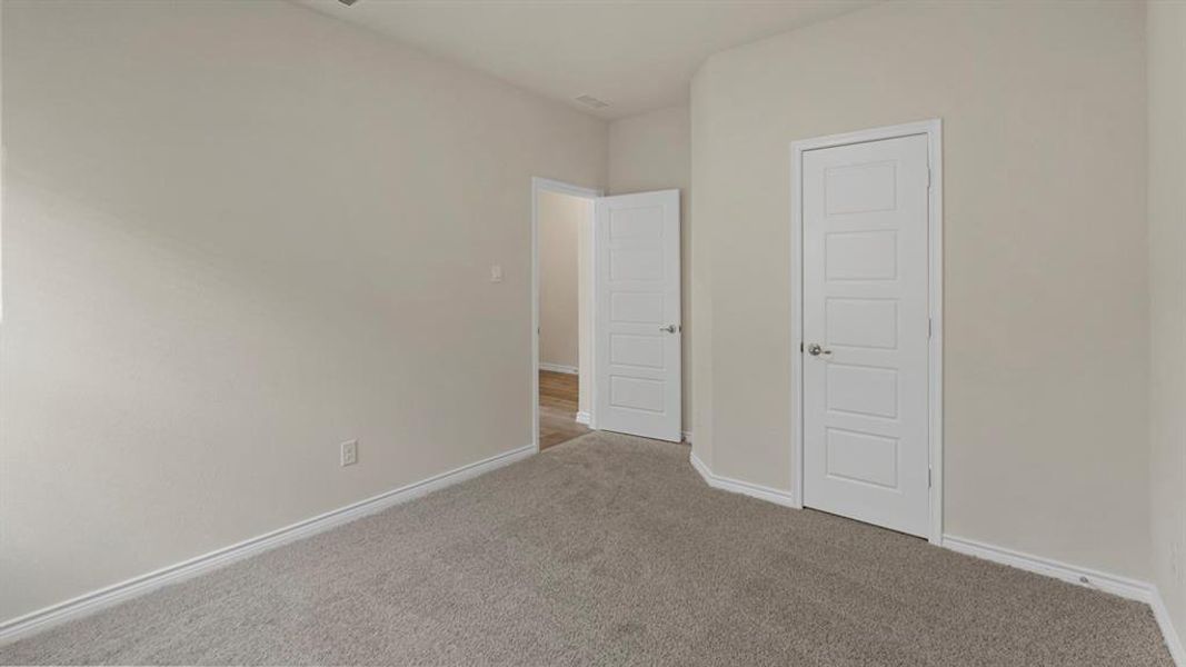 Neutral-toned walls and grey carpeting define this interior space