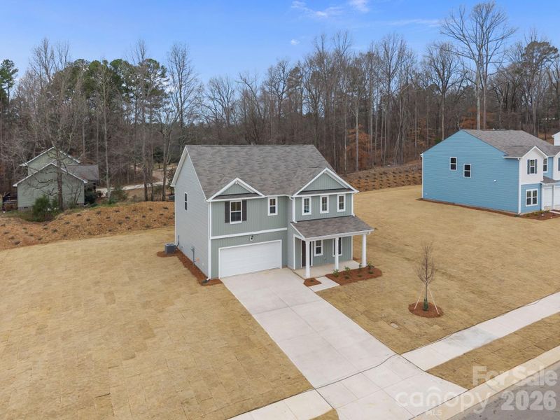 Front exterior of a new home in Fisher Springs, Kannapolis, NC, highlighting curb appeal (Image 10).