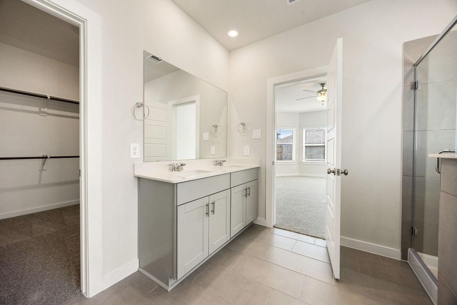 This primary bathroom is definitely move-in ready! Featuring stained cabinets with light countertops, spacious walk-in closet with shelving, high ceilings, recessed lighting, custom paint, sleek and dark modern finishes. This primary bathroom is definitely move-in ready! Featuring stained cabinets with light countertops, spacious walk-in closet with shelving, high ceilings, recessed lighting, custom paint, sleek and dark modern finishes.