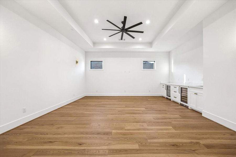 Spacious game room offers flexibility for media, play, or casual entertaining, complete with a built in wet bar for added convenience. Tray ceiling and generous floor space allow the room to adapt easily as needs evolve. **Previous build by Arch Angelo** Spacious game room offers flexibility for media, play, or casual entertaining, complete with a built in wet bar for added convenience. Tray ceiling and generous floor space allow the room to adapt easily as needs evolve. **Previous build by Arch Angelo**