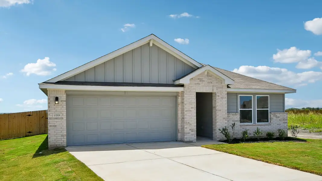 Front exterior of a new home in Carillon, Manor, TX, highlighting curb appeal (Image 2).
