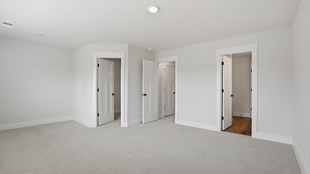 Primary suite that offers first-rate relaxation with established style and elevated finishes by DRB Homes Primary suite that offers first-rate relaxation with established style and elevated finishes by DRB Homes