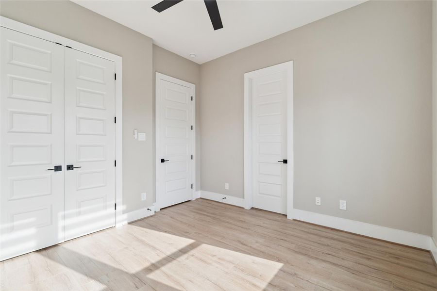 Neutral tones and wide-plank flooring anchor this room in softness and simplicity.
