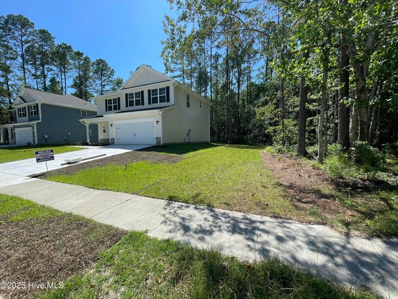 Front exterior of a new home in Mill Creek Cove, Bolivia, NC, highlighting curb appeal (Image 2).