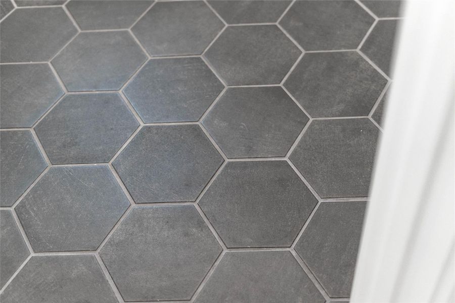 This Moroccan Hexagon tile serves as a stylish and highly functional foundation for a modern laundry room.