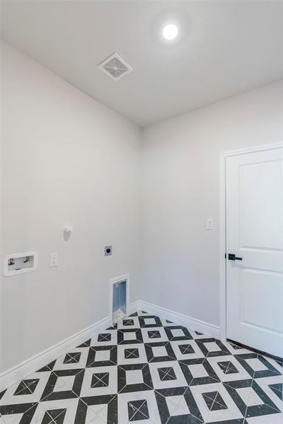 Clothes washing area featuring washer hookup and hookup for an electric dryer