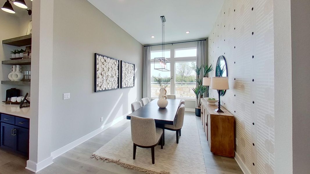 Dining room featuring light wood-style flooring and recessed lighting