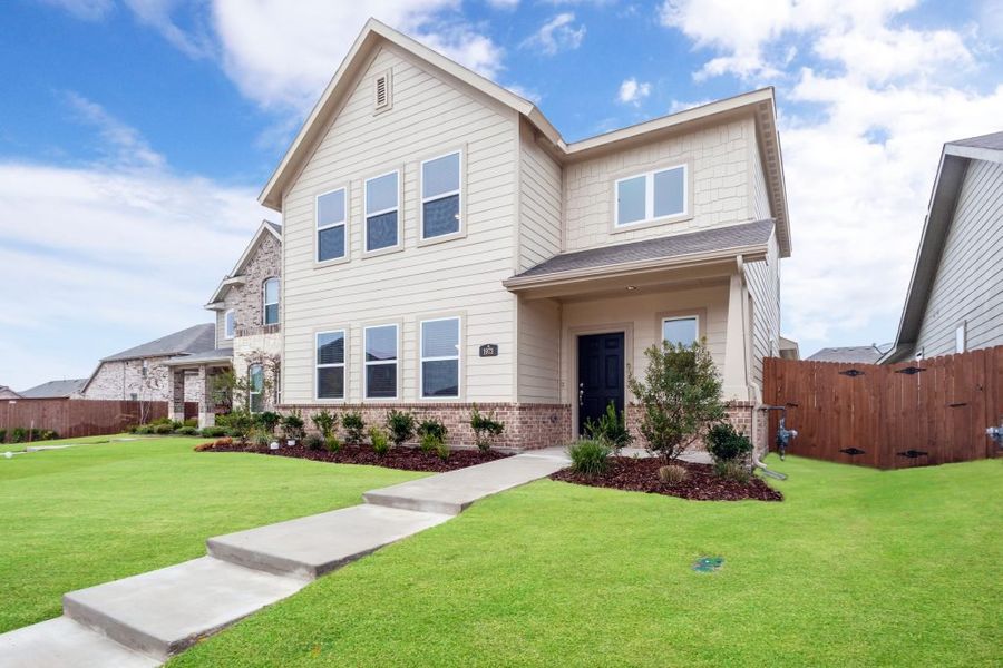 Representative exterior photo of a completed home built from the Harwood by Impression Homes in Heartland, Heartland, TX (Image 1).