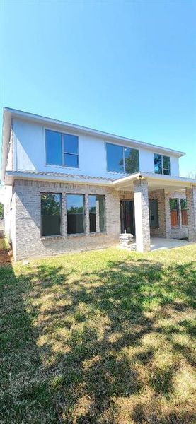 Back of property with a patio and a yard