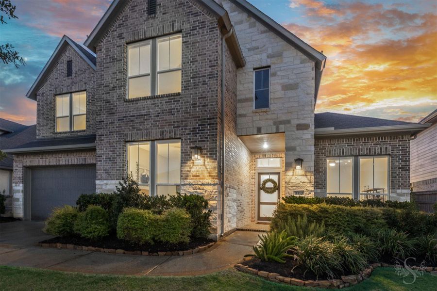 Striking brick-and-stone architecture gives this 2024 home a sophisticated modern presence in Cross Creek Ranch. Dramatic rooflines, warm exterior lighting and beautifully maintained landscaping create unforgettable curb appeal. Striking brick-and-stone architecture gives this 2024 home a sophisticated modern presence in Cross Creek Ranch. Dramatic rooflines, warm exterior lighting and beautifully maintained landscaping create unforgettable curb appeal.