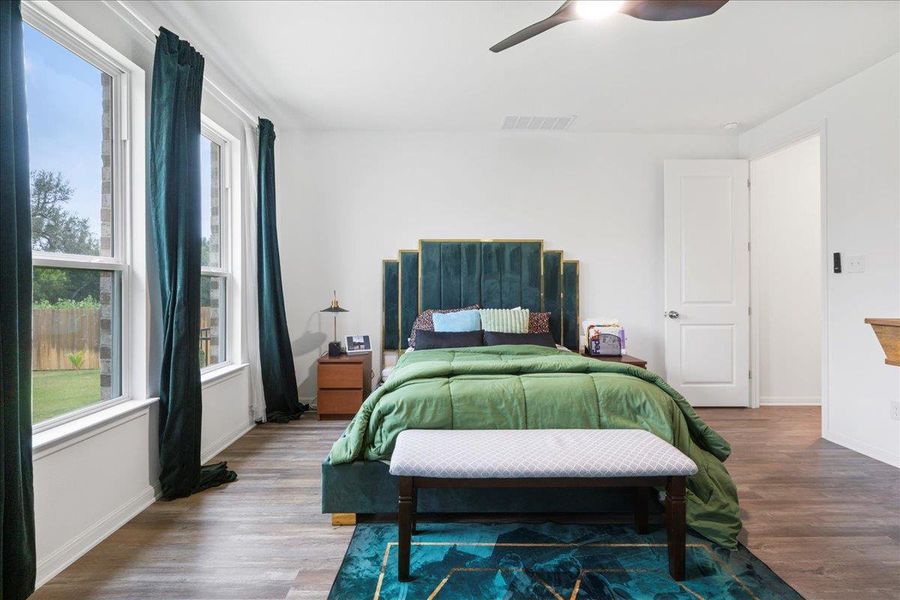 Bedroom featuring wood finished floors and a ceiling fan