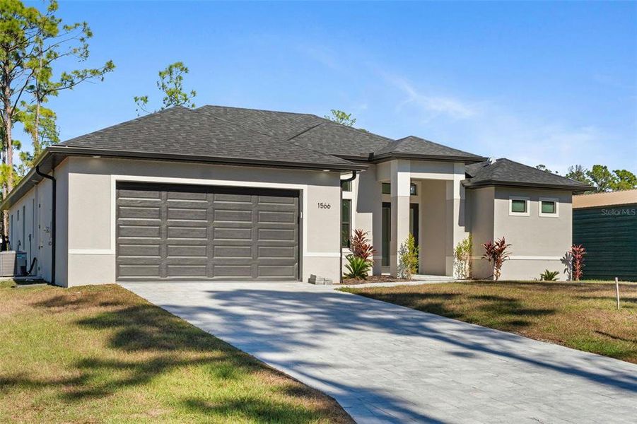 Front exterior of a new home in , North Port, FL, highlighting curb appeal (Image 1). Front exterior of a new home in , North Port, FL, highlighting curb appeal (Image 1).