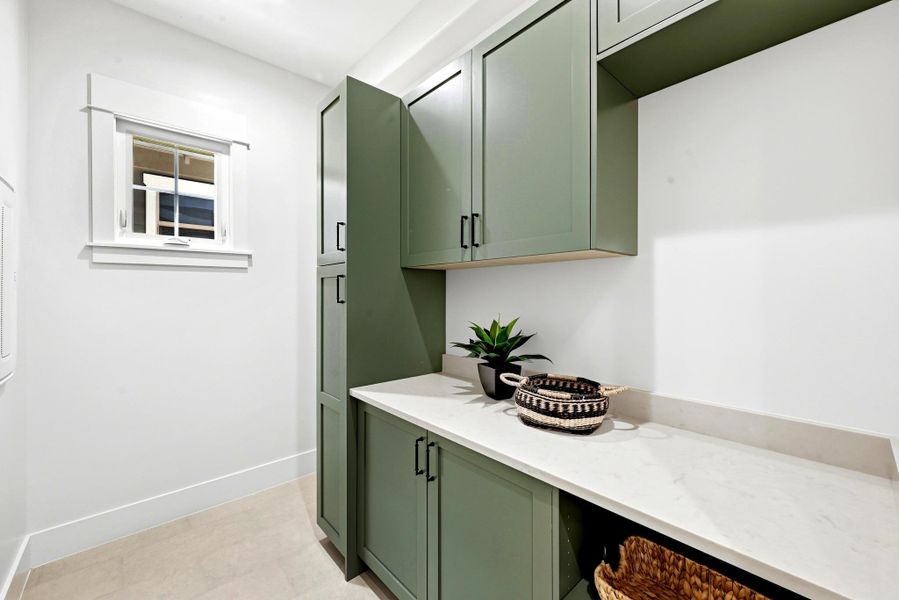 Ample storage cabinetry and practical counter space define this functional laundry area. Ample storage cabinetry and practical counter space define this functional laundry area.