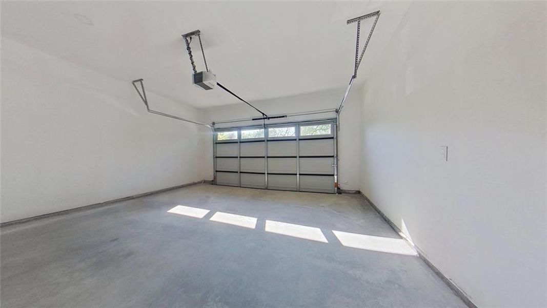 Garage featuring a garage door opener