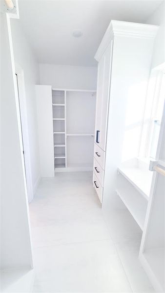 Spacious closet featuring light tile patterned flooring