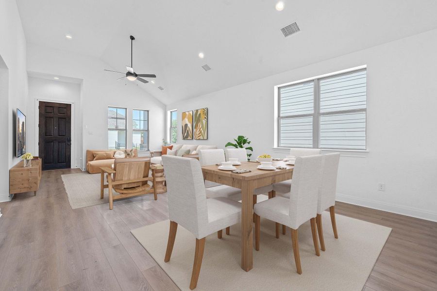 Dining area featuring a ceiling fan, light wood-style floors, high vaulted ceiling, and recessed lighting Dining area featuring a ceiling fan, light wood-style floors, high vaulted ceiling, and recessed lighting