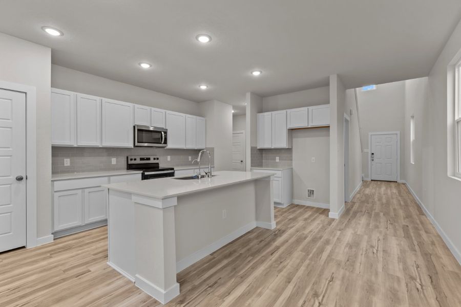 A kitchen with white cabinets. A kitchen with white cabinets.