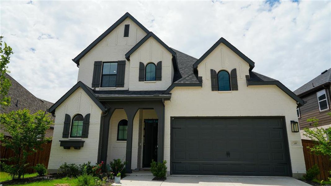 Front exterior of a new home in Sandbrock Ranch, Aubrey, TX, highlighting curb appeal (Image 1). Front exterior of a new home in Sandbrock Ranch, Aubrey, TX, highlighting curb appeal (Image 1).