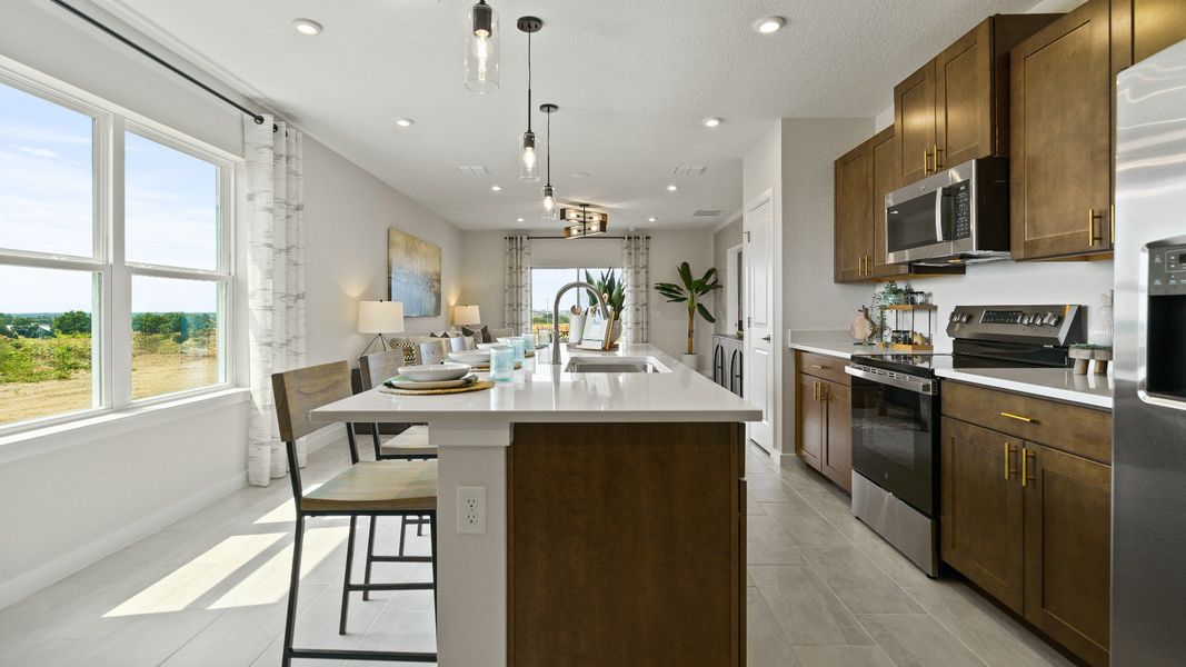 Spacious kitchen with island seating, stainless steel appliances, and a sunny dining nook—perfect for everyday meals.