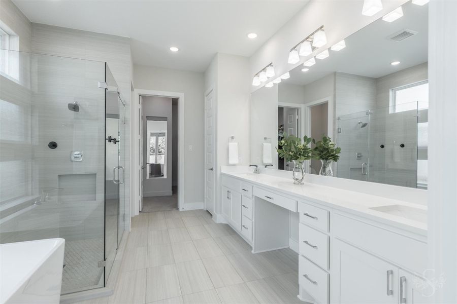 Luxurious primary bath features an extended dual quartz vanity with abundant cabinetry and an oversized frameless glass shower. Soft neutral finishes give the space a serene, spa-inspired feel. Luxurious primary bath features an extended dual quartz vanity with abundant cabinetry and an oversized frameless glass shower. Soft neutral finishes give the space a serene, spa-inspired feel.