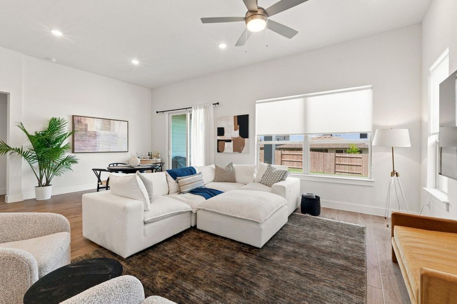 Bright and inviting main living space highlighting the open connection to the dining space and private covered back patio. Bright and inviting main living space highlighting the open connection to the dining space and private covered back patio.
