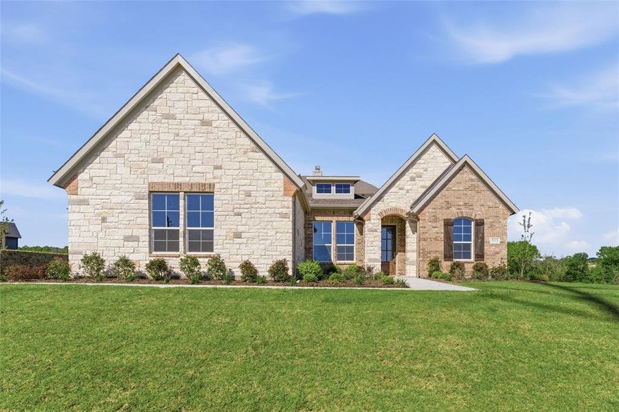 View of front of property featuring a front yard and stone siding
