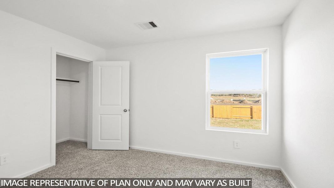 Unfurnished bedroom with light colored carpet and a closet Unfurnished bedroom with light colored carpet and a closet