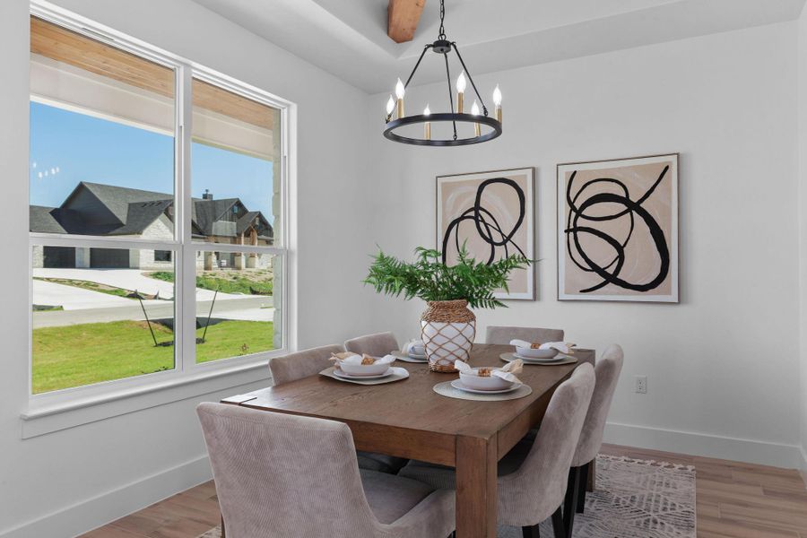 Dining room with suspended lighting and light wood-type flooring Dining room with suspended lighting and light wood-type flooring