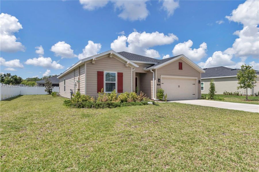 Front exterior of a new home in Country Lane Estates, Williston, FL, highlighting curb appeal (Image 21). Front exterior of a new home in Country Lane Estates, Williston, FL, highlighting curb appeal (Image 21).