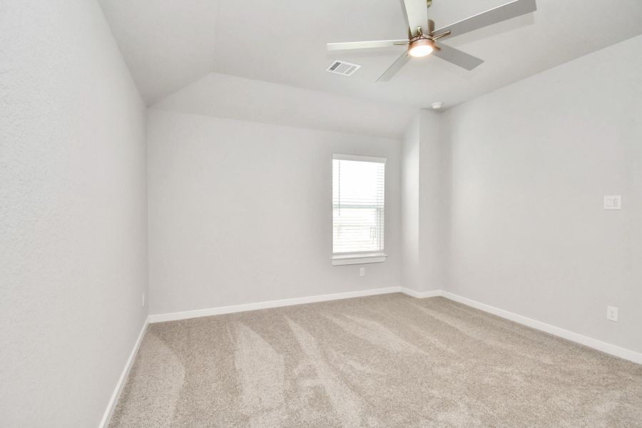 Secondary bedroom features plush carpeting, large windows that let in plenty of natural light, bright paint, and spacious closets. Sample photo of completed home with similar floor plan. Actual colors and selections may vary. Secondary bedroom features plush carpeting, large windows that let in plenty of natural light, bright paint, and spacious closets. Sample photo of completed home with similar floor plan. Actual colors and selections may vary.