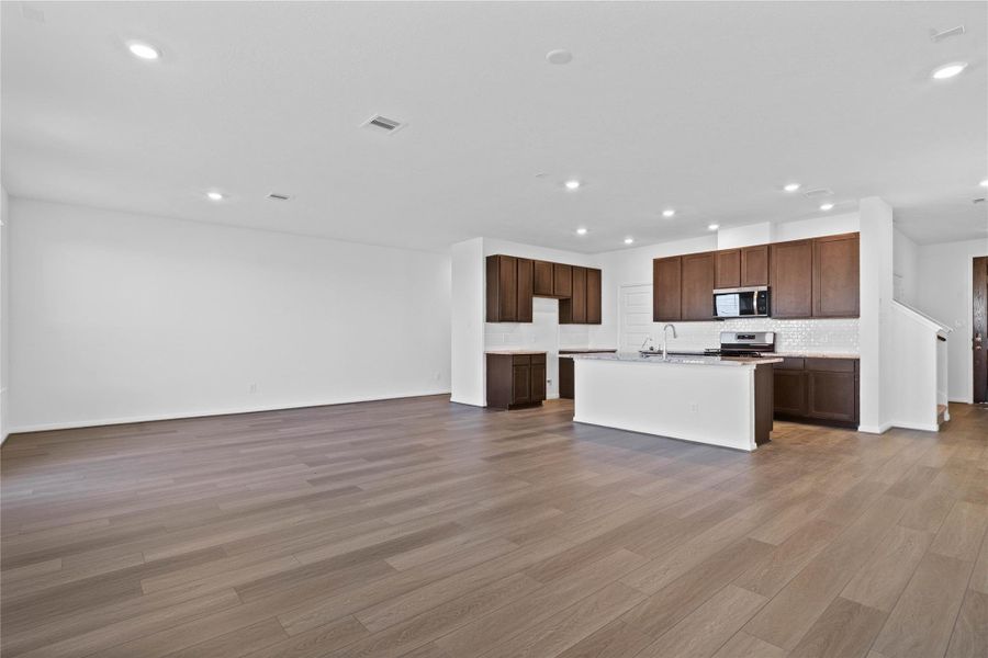 Stunning open-concept design seamlessly connecting the living, dining, and kitchen areas—perfect for both everyday living and entertaining!