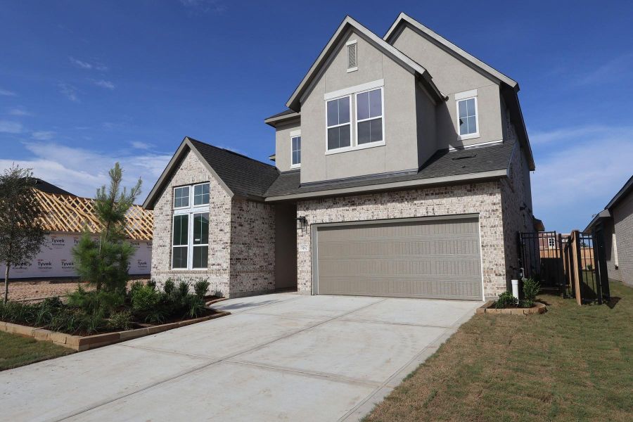 Front exterior of a new home in Woodson’s Reserve, Spring, TX, highlighting curb appeal (Image 2). Front exterior of a new home in Woodson’s Reserve, Spring, TX, highlighting curb appeal (Image 2).