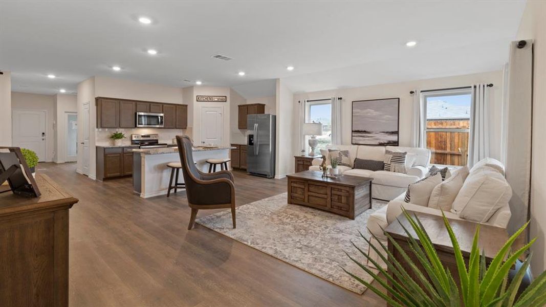 Living area featuring dark wood-type flooring and recessed lighting