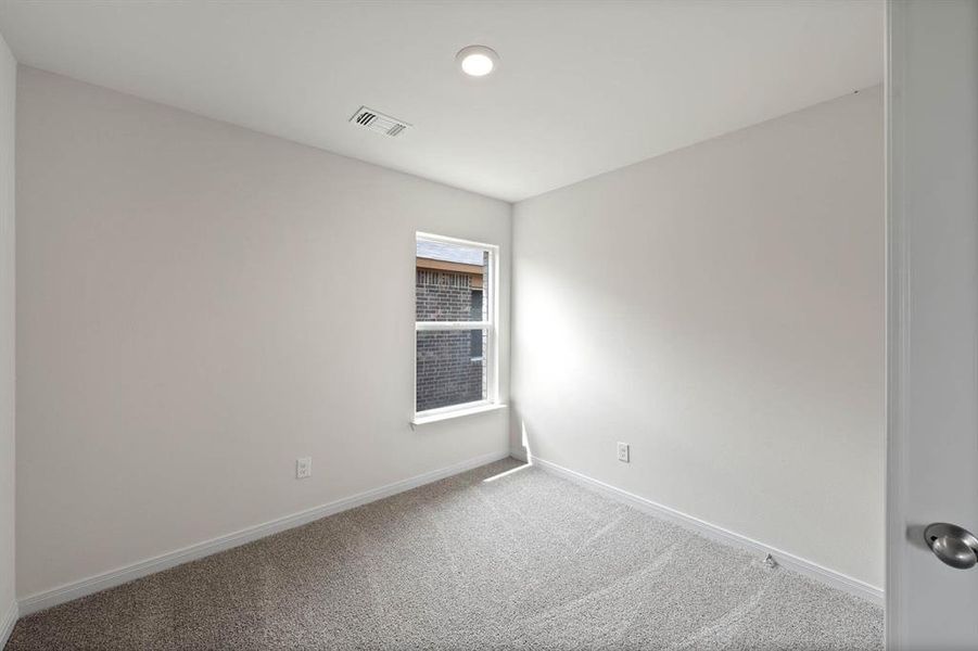 Carpeted spare room with baseboards Carpeted spare room with baseboards