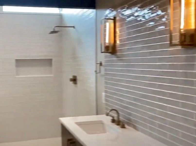 Bathroom featuring a shower stall and vanity